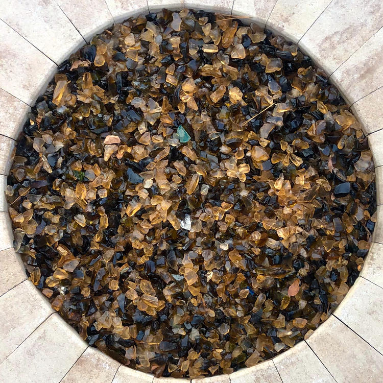 top down view of a round fire glass pit, not lit